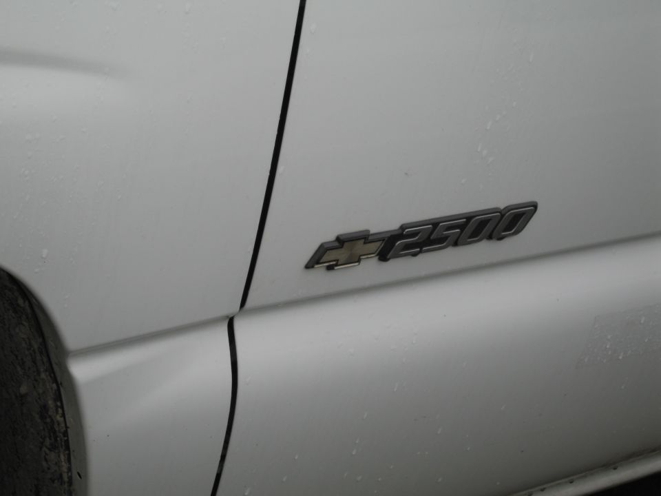 White truck door with a "2500" emblem and Chevrolet logo