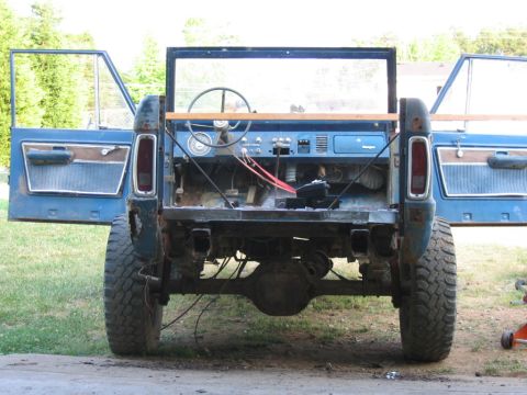 1992 Ford Mustang - This blue Ford Bronco is undergoing a build-up, with its interior exposed and doors ajar.