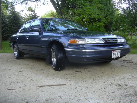 1996 Ford Crown Victoria - This 1995 Ford Crown Victoria is shown in a three-quarter front view, chrome wheels and a dark blue exterior.
