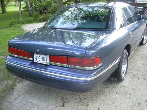 1996 Ford Crown Victoria - Rear view of a blue 1996 Ford Crown Victoria with custom wheels and chrome trim.