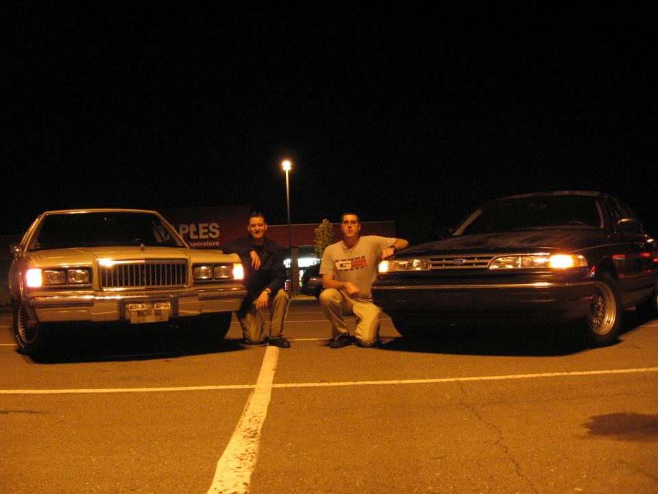 1988 Mercury Grand Marquis and a dark sedan parked at night