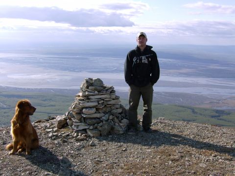 1982 Chevrolet C/K Pickup - A man and his dog enjoy a scenic view from a mountain summit.