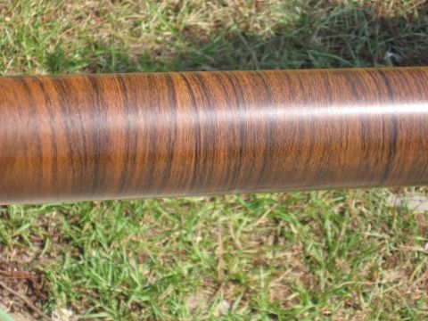 1973 Ford Ranchero - Cylindrical object with a wood grain finish is shown outdoors on grass.