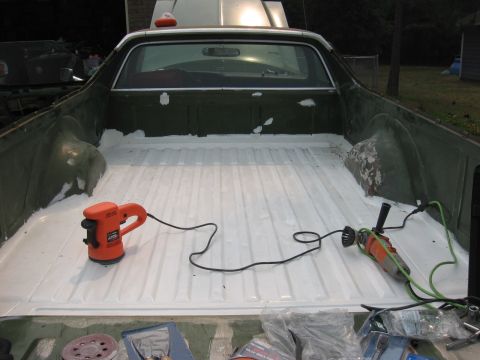 1973 Ford Ranchero - Tools are laid out in the bed of a vehicle, ready for work on the freshly coated surface.