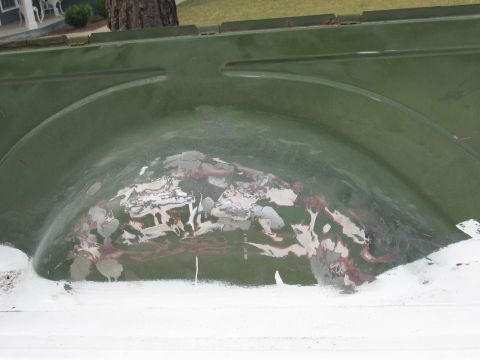 1973 Ford Ranchero - The interior of a 1973 Ford Ranchero's wheel well shows signs of repair with primer and rust.