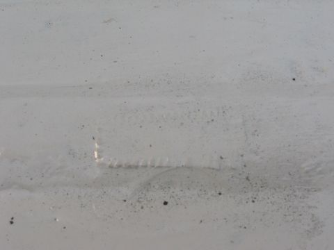 1973 Ford Ranchero - A close-up view of a white painted metal surface shows a rectangular indentation with visible texture, suggesting a part of a larger object.