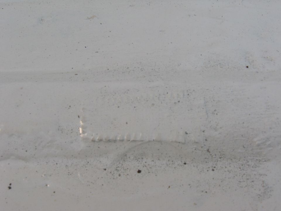 White painted metal with rectangular indentation and textured surface
