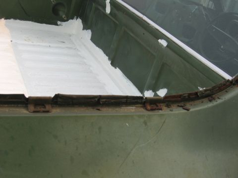 1973 Ford Ranchero - The bedliner of a 1973 Ford Ranchero shows signs of repair with white sealant and visible rust.