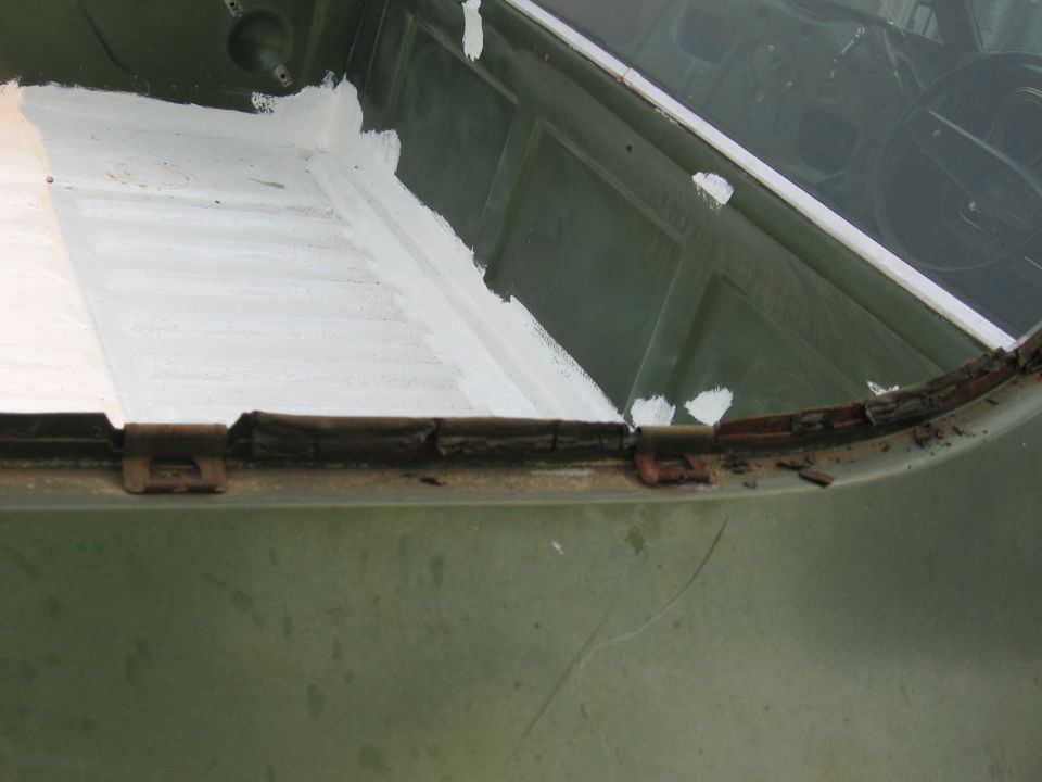 Green 1973 Ford Ranchero bedliner with white sealant and rust around the edge