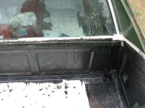 1973 Ford Ranchero - The bed liner of a 1973 Ford Ranchero shows a black spray-on coating over white paint.