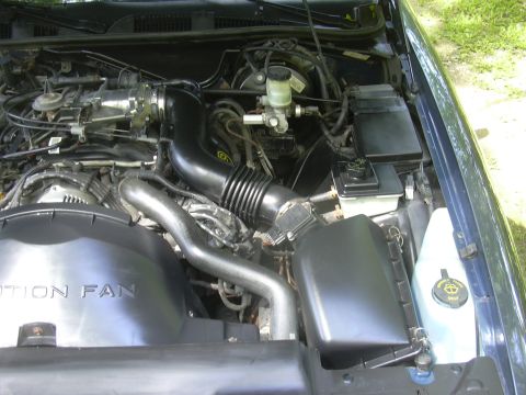1996 Ford Crown Victoria - Close-up view of the engine compartment, showing various components and hoses.