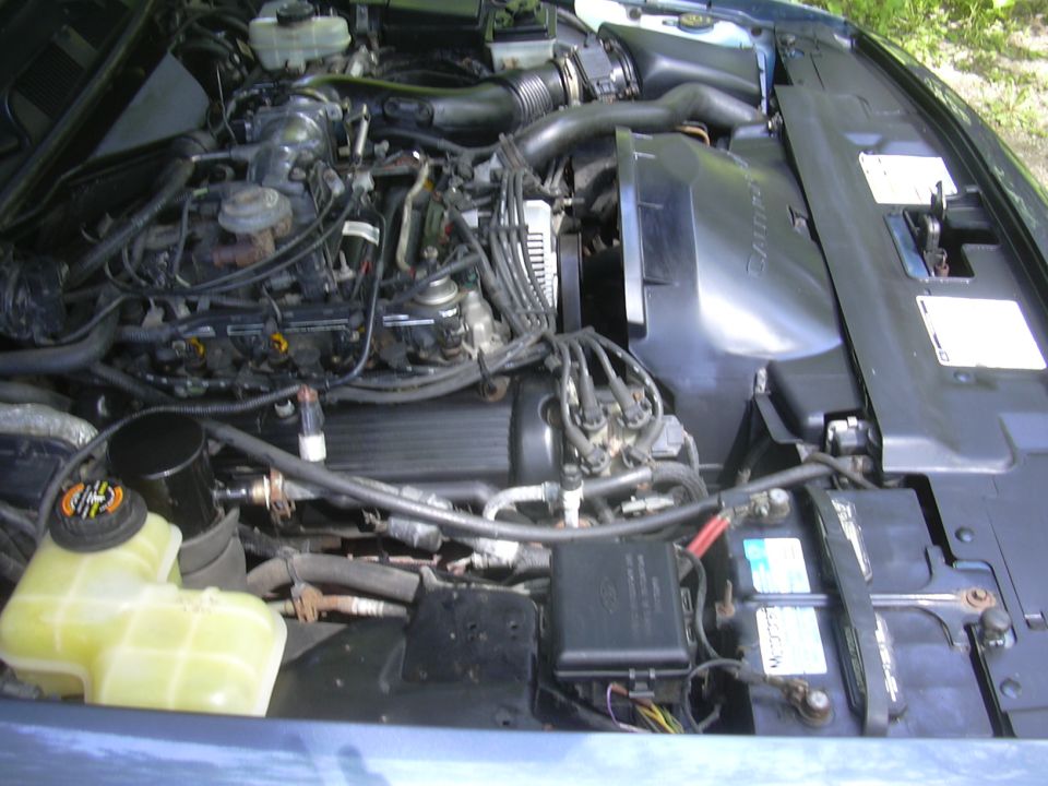 Engine bay with visible battery and coolant reservoir