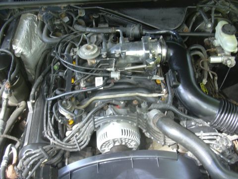 1996 Ford Crown Victoria - Close-up view of a vehicle's engine compartment, showing various mechanical components.