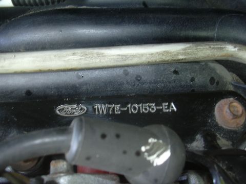 1996 Ford Crown Victoria - Close-up of a Ford engine part showing the manufacturer's logo and part number.
