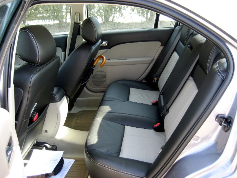 2007 Mercury Milan interior showing rear seats, door panels, and seatbelts