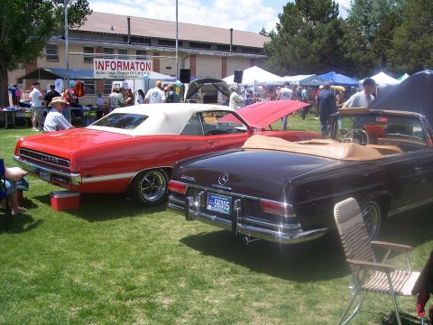 1972 Ford Ranchero - Two classic convertibles, a 1972 Ford Ranchero and a Mercedes, displayed at an outdoor car show.