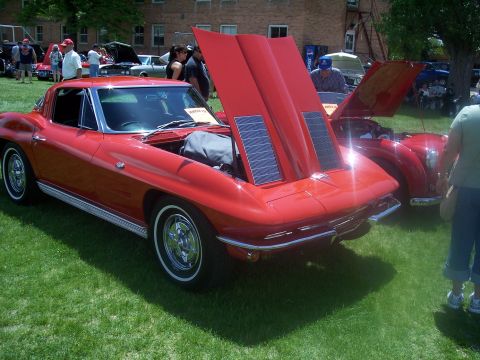 1972 Ford Ranchero - A red 1963 Corvette Stingray is displayed with its hood open, revealing solar panels.
