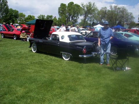 1972 Ford Ranchero - A black 1957 Ford Thunderbird convertible with a white top and wire wheels is displayed at a car show.