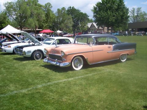 1972 Ford Ranchero - A two-tone pink and gray 1955 Chevrolet Bel Air is displayed at a car show alongside other vehicles.