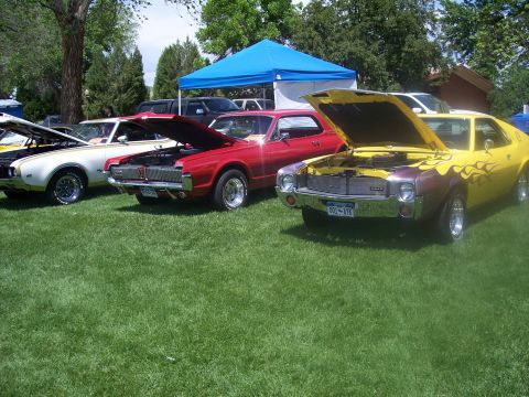1972 Ford Ranchero - Several vintage automobiles are displayed on a grassy field under a blue tent.
