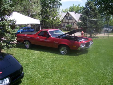 1972 Ford Ranchero - A red 1972 Ford Ranchero is displayed with its hood open at a car show.