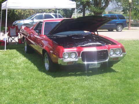 1972 Ford Ranchero - Red 1972 Ford Ranchero at a car show, hood raised to display the engine.