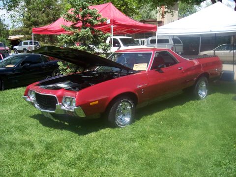 1972 Ford Ranchero - A red 1972 Ford Ranchero is displayed with its hood up at an outdoor event.