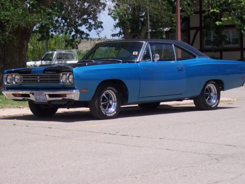 1972 Ford Ranchero - A blue 1969 Plymouth Road Runner is parked outdoors, with a white truck visible in the background.