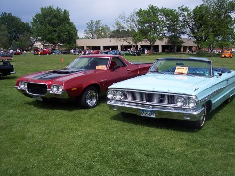 1972 Ford Ranchero - A red 1972 Ford Ranchero is parked next to a light blue convertible at a car show.
