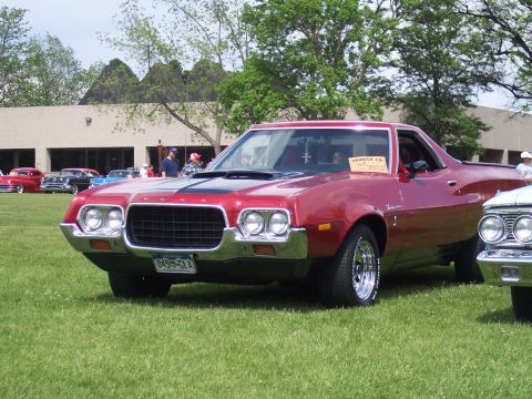 1972 Ford Ranchero - 1972 Ford Ranchero on display at a car show, with other vehicles and a building in the background.