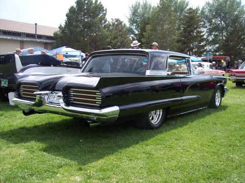 1972 Ford Ranchero - A classic black Ford Fairlane 500 Skyliner is parked on a grassy field at an outdoor car show.