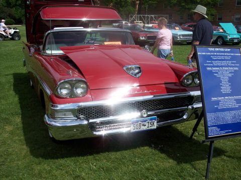 1972 Ford Ranchero - A red 1958 Ford Fairlane convertible is displayed at a car show with its hood and trunk open.