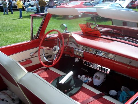 1972 Ford Ranchero - Interior view of a red convertible, likely a 1957 model, with a white and red striped interior and dashboard details visible.