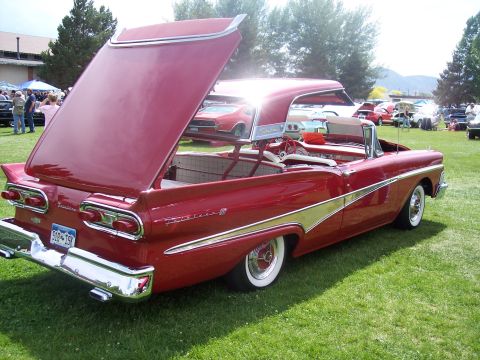 1972 Ford Ranchero - Red 1957 Ford Fairlane convertible at a car show, trunk open.