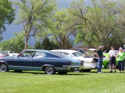 1972 Ford Ranchero - A two-tone blue and teal coupe is displayed at a car show alongside other vehicles.