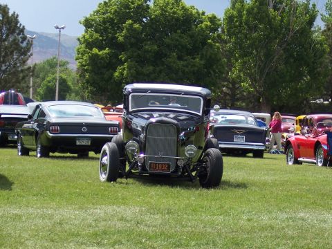 1972 Ford Ranchero - A 1932 Ford hot rod is displayed at a car show, alongside other classic and modern vehicles.
