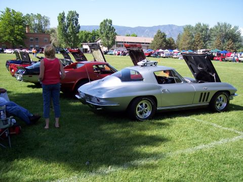 1972 Ford Ranchero - A classic Corvette Sting Ray is displayed at an outdoor car show with other vehicles present.