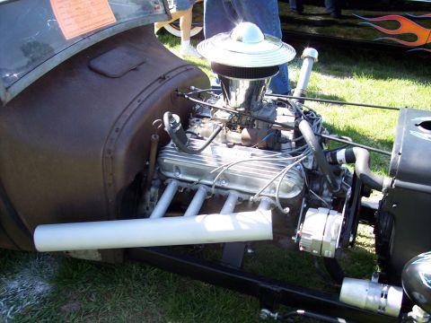 1972 Ford Ranchero - The engine bay of a custom hot rod is shown, a V8 engine with aftermarket parts.