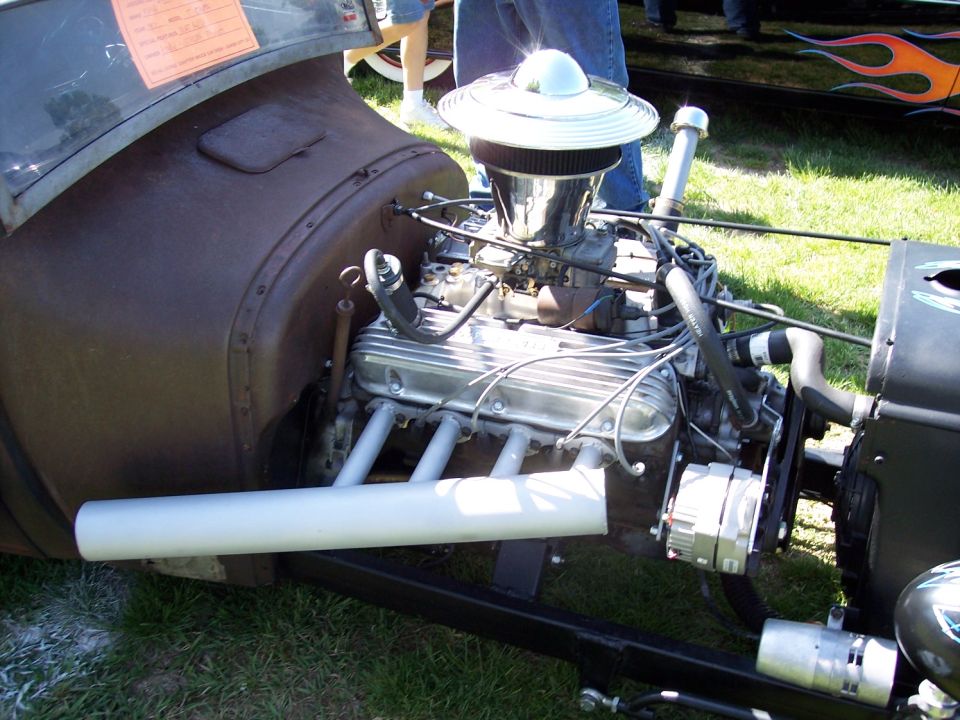 Close-up of a V8 engine in a hot rod, with chrome air cleaner and exhaust headers