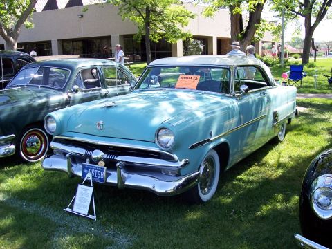 1972 Ford Ranchero - A light blue two-tone coupe is displayed at a car show, parked next to other vehicles on a grassy lawn.