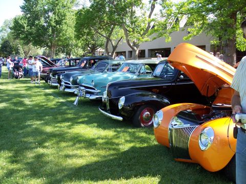 1972 Ford Ranchero - A collection of vintage automobiles are displayed on a sunny day at an outdoor car show.