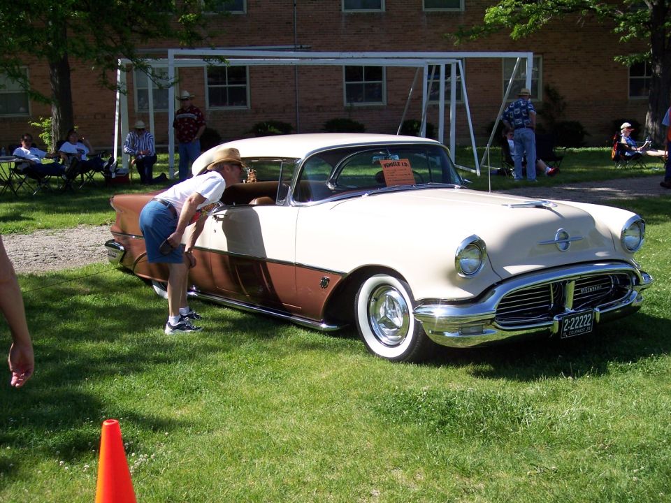 Two-tone beige and brown 1955 Oldsmobile 88 with whitewall tires