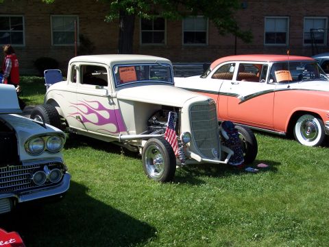 1972 Ford Ranchero - Custom hot rod coupe with flame graphics and a 1950s sedan in the background at a car show.