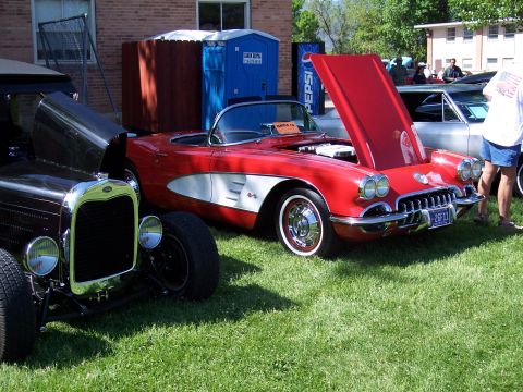 1972 Ford Ranchero - A red 1958 Chevrolet Corvette convertible is displayed with its hood open at a car show.