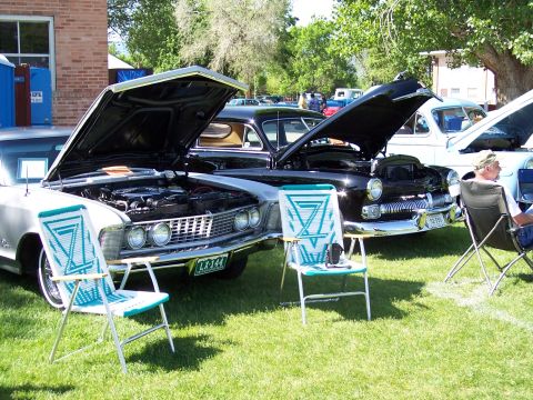 1972 Ford Ranchero - Several vintage automobiles are displayed with their engines exposed at an outdoor event.