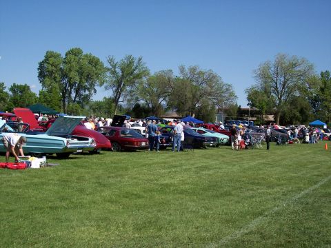 1972 Ford Ranchero - A variety of cars are displayed on a sunny day at an outdoor car show.