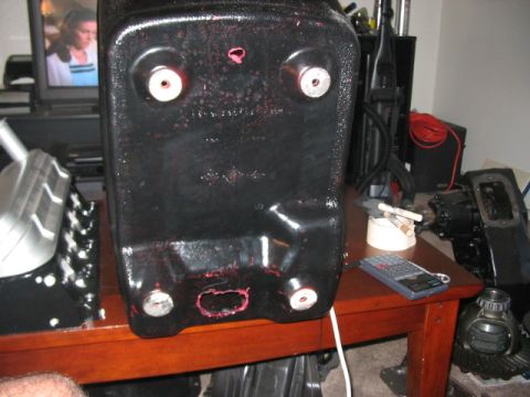 1991 Ford Bronco - A black plastic component with visible wear and tear sits on a table, with other items in the background.