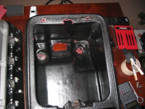 1991 Ford Bronco - Center console storage bin, possibly from a Ford Bronco, shows signs of wear and red residue.