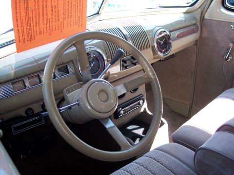 1972 Ford Ranchero - The interior of a classic automobile features a prominent steering wheel and dashboard with various gauges and a clock.