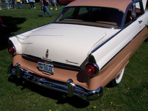 1972 Ford Ranchero - Rear view of a two-tone 1955 Ford Fairlane Crown Victoria parked on grass.